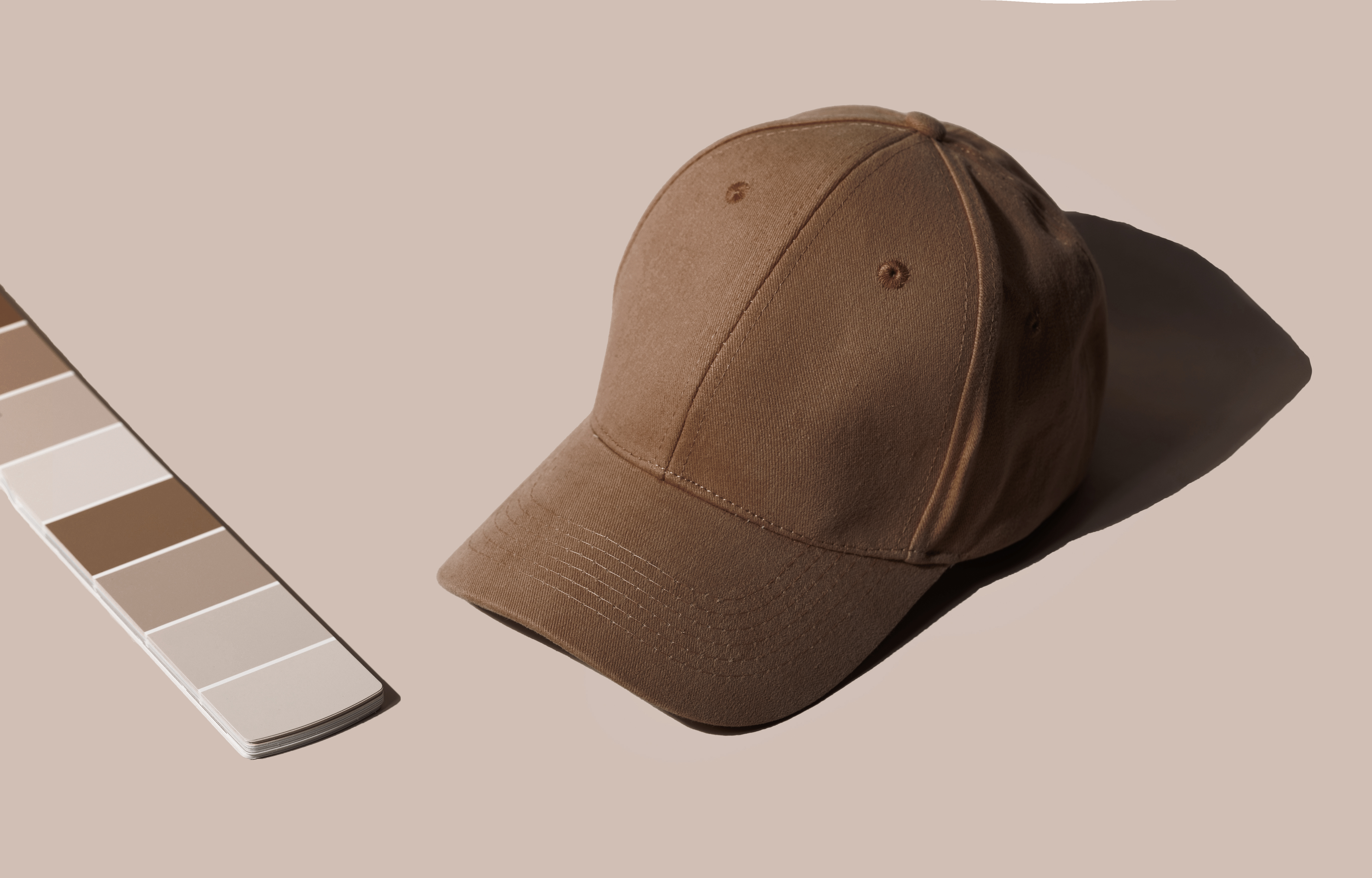 Brown cap photographed beside a neutral color palette